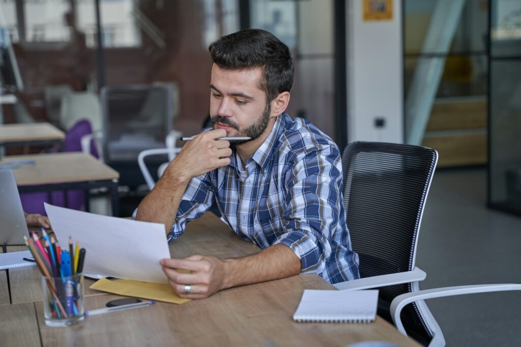 Worker thinking about success and development of corporation